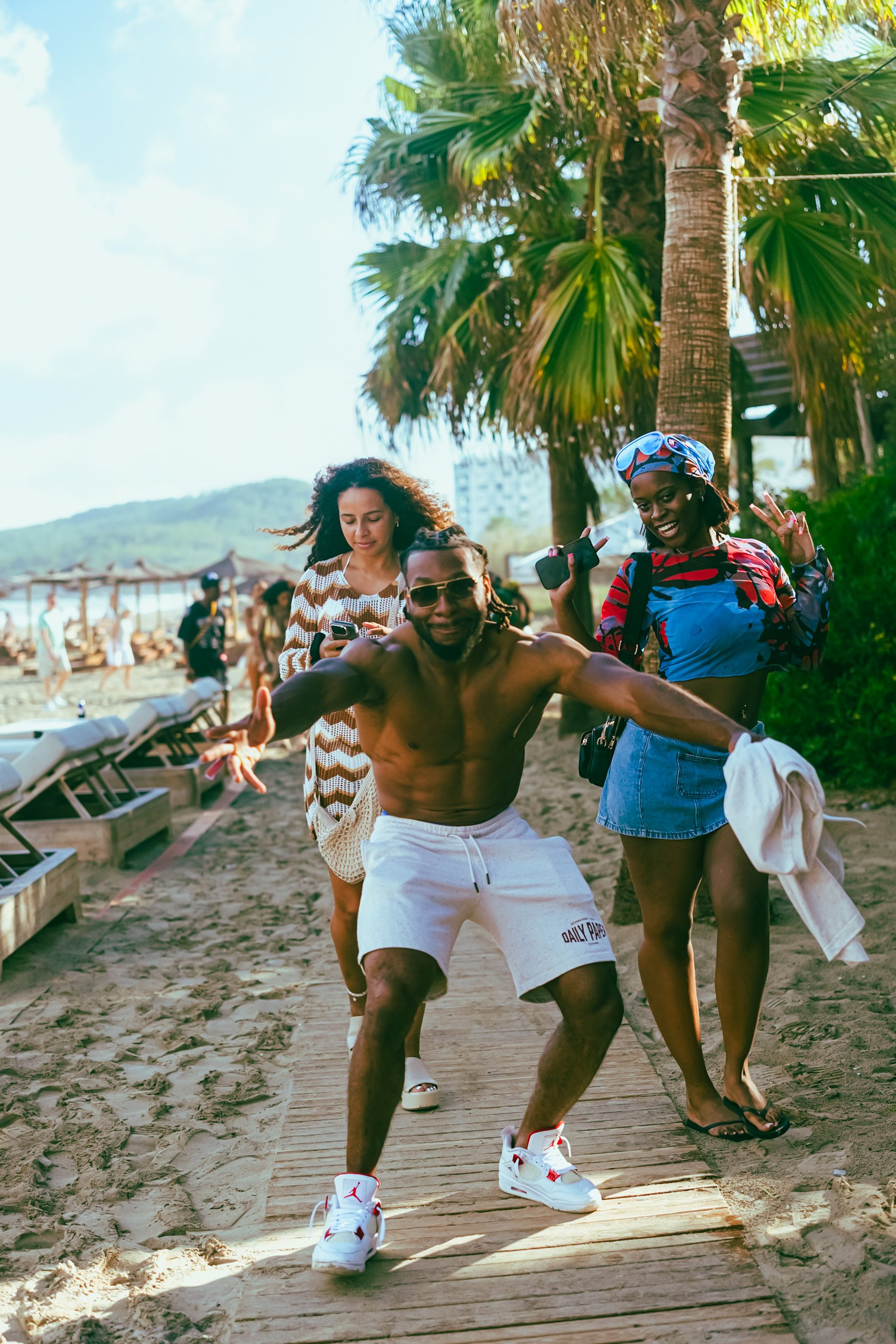 Guests dancing under the palms at a BykonzYard day party